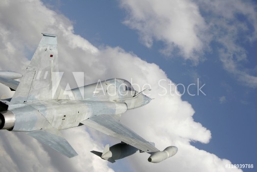 Picture of Fighter Jet Against White Clouds And Blue Sky